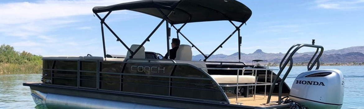 A man floating on a Coach Pontoon FRL on a high desert lake.